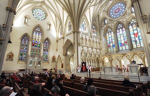 Bishop Richard J. Malone presides over the the Solemn Celebration of the Lord's Passion at St. Joseph Cathedral. (Dan Cappellazzo/Staff Photographer)